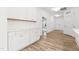 Bright hallway featuring white cabinetry, wood floors, and plenty of storage at 3011 Bourbon St, Sanford, NC 27332