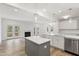 Open concept kitchen and living room area featuring fireplace and natural light at 3011 Bourbon St, Sanford, NC 27332