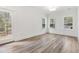 Bright living room features wood floors, white trim, and large windows at 3011 Bourbon St, Sanford, NC 27332