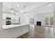 Open-concept living room with modern kitchen island, fireplace, and natural light at 3011 Bourbon St, Sanford, NC 27332