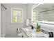 Bright bathroom with granite counters, modern lighting, and a large window at 305 Gillis Rd, Roxboro, NC 27574
