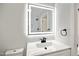 Beautifully updated bathroom with a large illuminated mirror and modern fixtures at 305 Gillis Rd, Roxboro, NC 27574