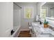 Renovated bathroom featuring modern fixtures, granite counters, and shower with tub at 305 Gillis Rd, Roxboro, NC 27574
