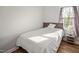 Cozy bedroom with natural light features hardwood floors and a neutral color palette at 305 Gillis Rd, Roxboro, NC 27574