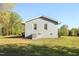 Exterior view showcasing the side of the house and spacious backyard at 305 Gillis Rd, Roxboro, NC 27574