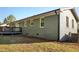 The exterior features a brick facade, a deck, and a well-maintained lawn at 305 Gillis Rd, Roxboro, NC 27574
