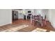 Open kitchen with white cabinets, stainless steel appliances, and laminate flooring, perfect for modern living at 305 Gillis Rd, Roxboro, NC 27574