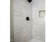 Walk-in shower featuring white tiled walls with a gold accent niche at 305 Gillis Rd, Roxboro, NC 27574