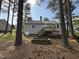 Backyard with trees, wooden deck, and space to relax at 308 Caroline Dr, Wendell, NC 27591