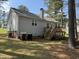 Backyard with wooden deck, green space, and mature trees at 308 Caroline Dr, Wendell, NC 27591