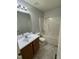 Neutral bathroom featuring a single sink vanity and a tub with shower at 308 Caroline Dr, Wendell, NC 27591
