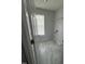 Bright laundry room with window and gray tiled floors; washer and dryer hookups available at 308 Caroline Dr, Wendell, NC 27591