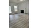 Inviting living room with a fireplace, new flooring, and plenty of natural light at 308 Caroline Dr, Wendell, NC 27591