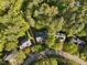 Aerial view showcases the property's location on a tree-lined street and its well-manicured lawn at 308 Sunset Creek Cir, Chapel Hill, NC 27516
