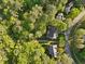 Aerial view of the property nestled among mature trees in a well-established neighborhood at 308 Sunset Creek Cir, Chapel Hill, NC 27516