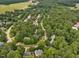 Aerial view of the community showcases the homes nestled among mature trees at 308 Sunset Creek Cir, Chapel Hill, NC 27516