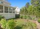 Manicured backyard with a screen porch, garden, and privacy fence offers a serene outdoor living space at 308 Sunset Creek Cir, Chapel Hill, NC 27516