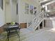 Back porch and stair access to backyard, featuring an outdoor grill at 308 Sunset Creek Cir, Chapel Hill, NC 27516