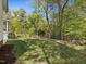 Backyard with green grass and lush trees at 308 Sunset Creek Cir, Chapel Hill, NC 27516