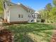 This fenced-in backyard features a lush, level lawn, a screened porch, and easy access from the main house at 308 Sunset Creek Cir, Chapel Hill, NC 27516
