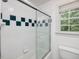 Modern bathroom showing a glass shower with decorative tiling and a window with natural light at 308 Sunset Creek Cir, Chapel Hill, NC 27516