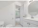 Bright bathroom features a single sink vanity, with white cabinets and a mirrored medicine cabinet at 308 Sunset Creek Cir, Chapel Hill, NC 27516