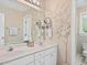 Bathroom with double sinks, white cabinetry, and a decorative tree painted on the wall at 308 Sunset Creek Cir, Chapel Hill, NC 27516