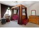 Bedroom with a four-poster bed, red comforter, and wood furniture at 308 Sunset Creek Cir, Chapel Hill, NC 27516