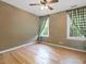 Bright, empty bedroom features wood floors, neutral paint and two windows at 308 Sunset Creek Cir, Chapel Hill, NC 27516