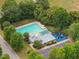Aerial view of a pristine community pool with ample seating and a playground nearby at 308 Sunset Creek Cir, Chapel Hill, NC 27516