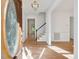 Sunlit foyer features hardwood floors, chandelier, and view of the staircase at 308 Sunset Creek Cir, Chapel Hill, NC 27516