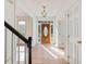 Inviting foyer with hardwood floors, stairs, and a wood door with glass at 308 Sunset Creek Cir, Chapel Hill, NC 27516