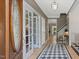 Foyer boasts checkered tile, wood floors, and charming accents, leading to various rooms at 308 Sunset Creek Cir, Chapel Hill, NC 27516
