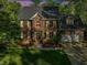 A classic brick home featuring a manicured lawn and mature trees at 308 Sunset Creek Cir, Chapel Hill, NC 27516