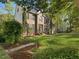 Brick home with a well-manicured front yard, professional landscaping, and a charming front entrance at 308 Sunset Creek Cir, Chapel Hill, NC 27516