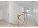 Upstairs hallway featuring natural light and a wooden railing at 308 Sunset Creek Cir, Chapel Hill, NC 27516