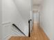 Upstairs hallway features hardwood flooring and natural light with views of the stairwell at 308 Sunset Creek Cir, Chapel Hill, NC 27516
