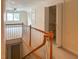 Hallway with carpet and wood banister leading to a naturally lit upstairs room at 308 Sunset Creek Cir, Chapel Hill, NC 27516