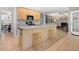 Open-concept kitchen with an island, breakfast bar, stainless appliances, and access to living room at 308 Sunset Creek Cir, Chapel Hill, NC 27516