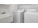 Bright laundry room with a utility sink, washer, and dryer at 308 Sunset Creek Cir, Chapel Hill, NC 27516