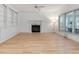 Bright living room with fireplace, built-in shelving, and large windows at 308 Sunset Creek Cir, Chapel Hill, NC 27516