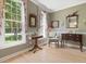Cozy living room with large windows, wood floors, crown molding, and comfortable furniture at 308 Sunset Creek Cir, Chapel Hill, NC 27516