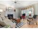 Inviting living room with a fireplace, large windows, and beautiful hardwood floors at 308 Sunset Creek Cir, Chapel Hill, NC 27516