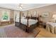 Comfortable main bedroom with a four-poster bed, area rug, and neutral decor for a relaxing retreat at 308 Sunset Creek Cir, Chapel Hill, NC 27516