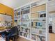 Office bookcase with multiple shelves containing books, boxes, and decorations at 308 Sunset Creek Cir, Chapel Hill, NC 27516