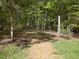 A tranquil mulch pathway leading through a lush, wooded area on the property at 308 Sunset Creek Cir, Chapel Hill, NC 27516