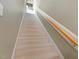 Carpeted staircase featuring natural wood banister and painted risers at 308 Sunset Creek Cir, Chapel Hill, NC 27516