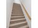 Carpeted staircase with wood railing leading to the next level of the home at 308 Sunset Creek Cir, Chapel Hill, NC 27516