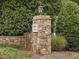 Stone entrance sign for Sunset Creek neighborhood, surrounded by lush green landscaping at 308 Sunset Creek Cir, Chapel Hill, NC 27516