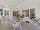 Covered sunroom featuring whitewashed furniture, lots of natural light, and tranquil views of the surrounding landscape at 308 Sunset Creek Cir, Chapel Hill, NC 27516